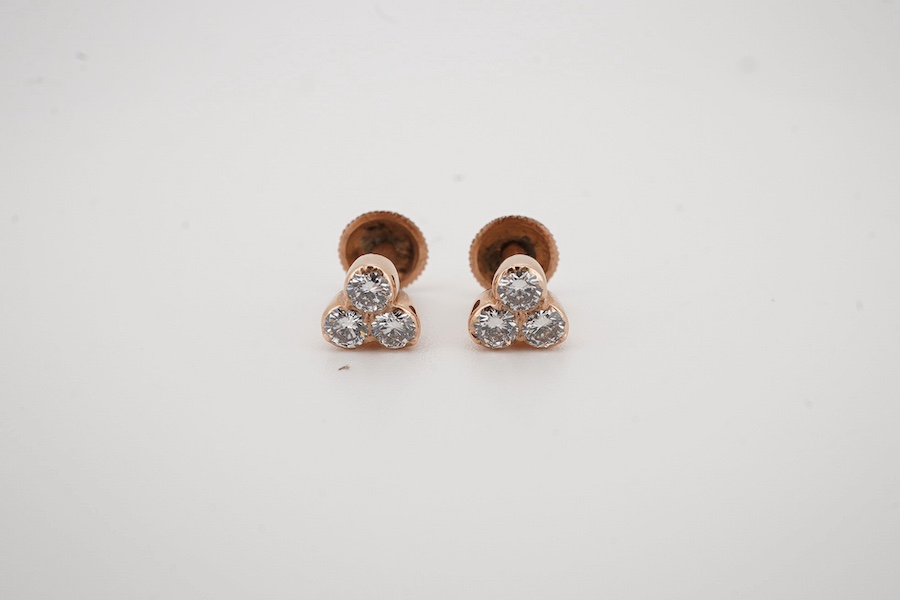 A par of 14k and three stone diamond cluster set ear studs, with a total diamond weight of approximately 0.90ct, gross weight 1.5 grams. Condition - good